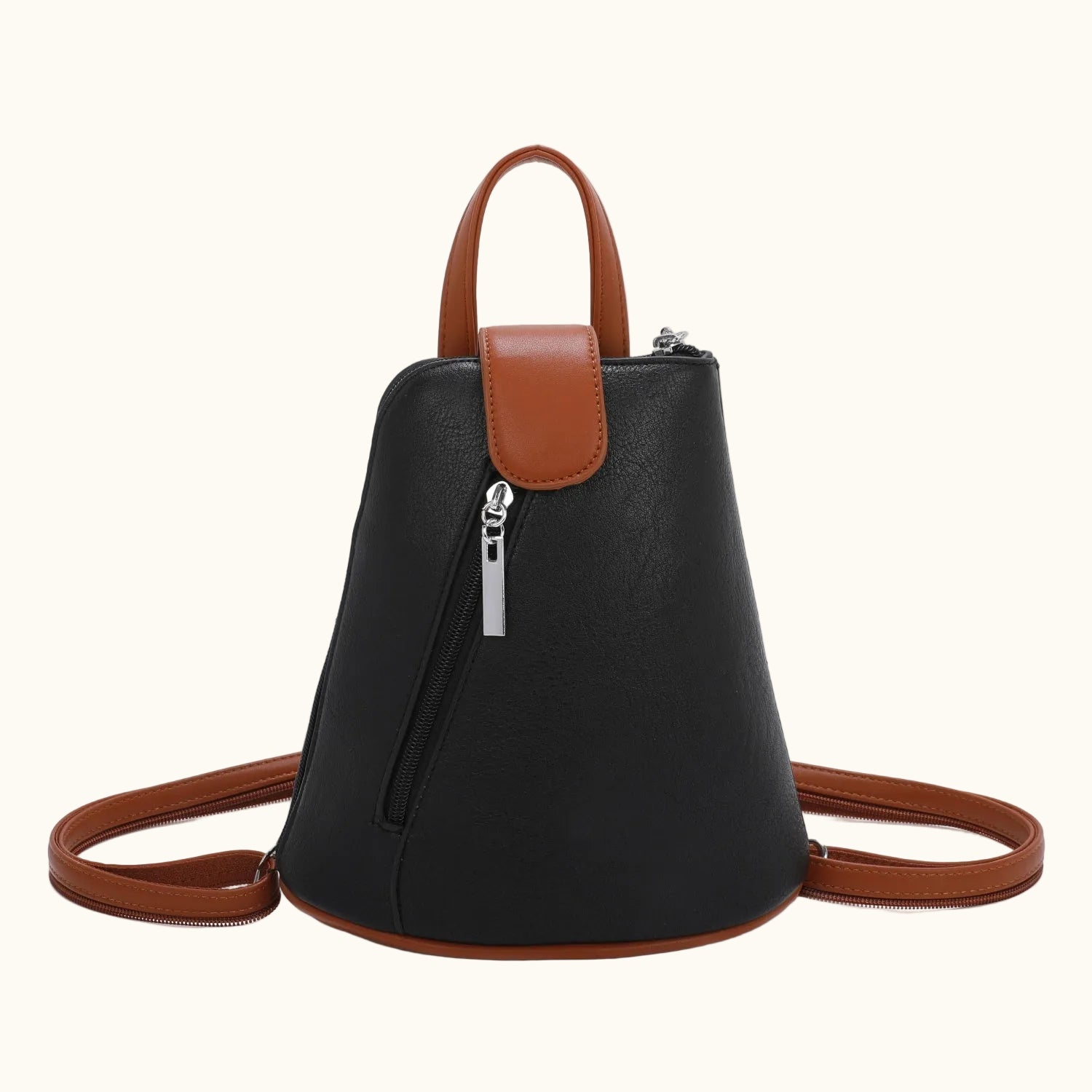 Black backpack with brown leather straps and handle on a white background
