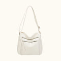 White handbag with a shoulder strap on a white background