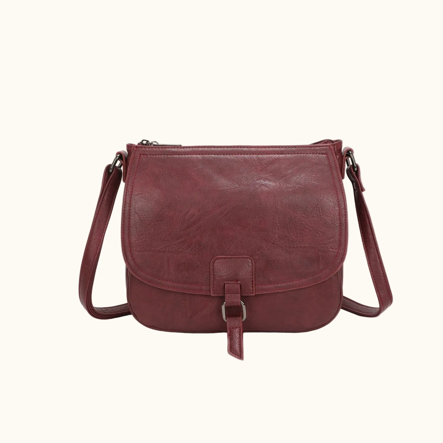 Red leather crossbody bag on a white background
