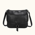 Black leather handbag with a strap on a white background