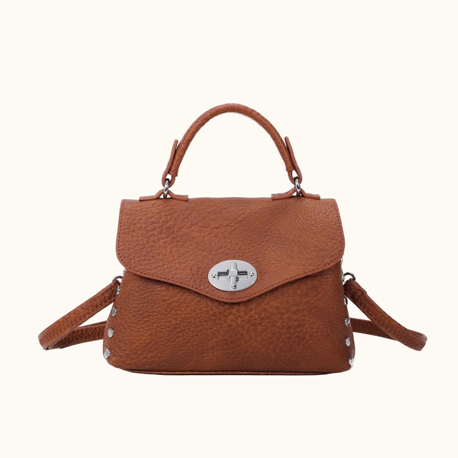 Brown leather handbag with a silver clasp on a white background