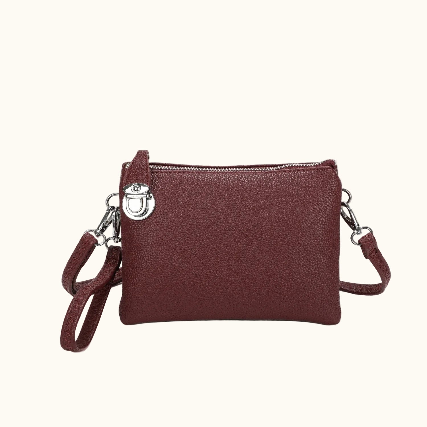 Brown leather crossbody bag with a strap on a white background