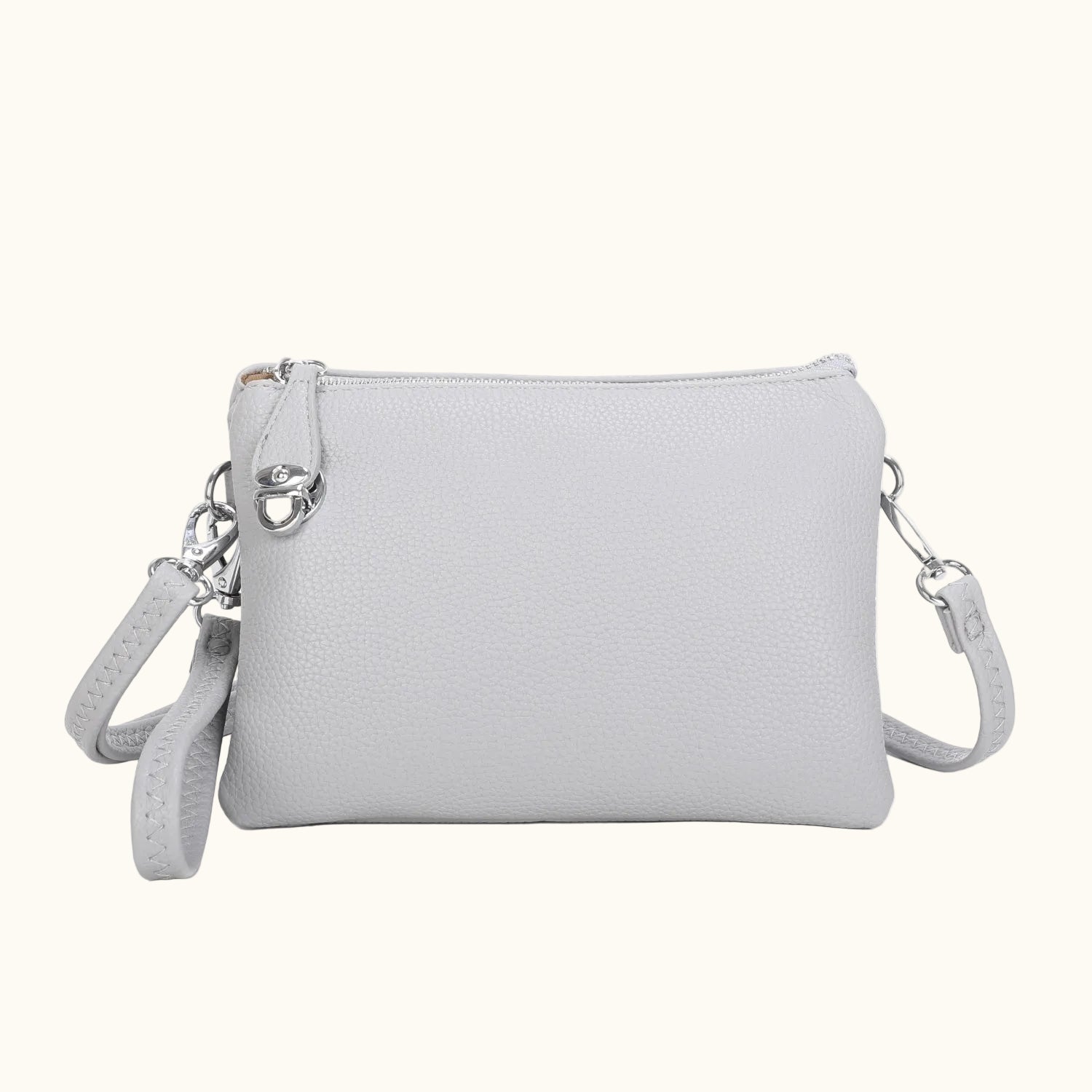 Light gray crossbody bag with a strap on a white background