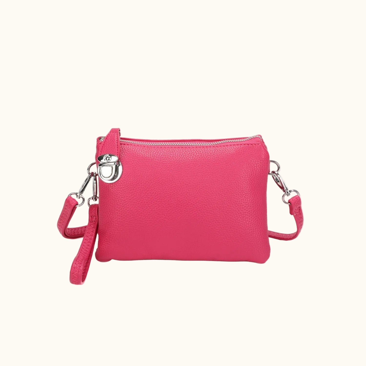 Pink crossbody bag with a strap on a white background