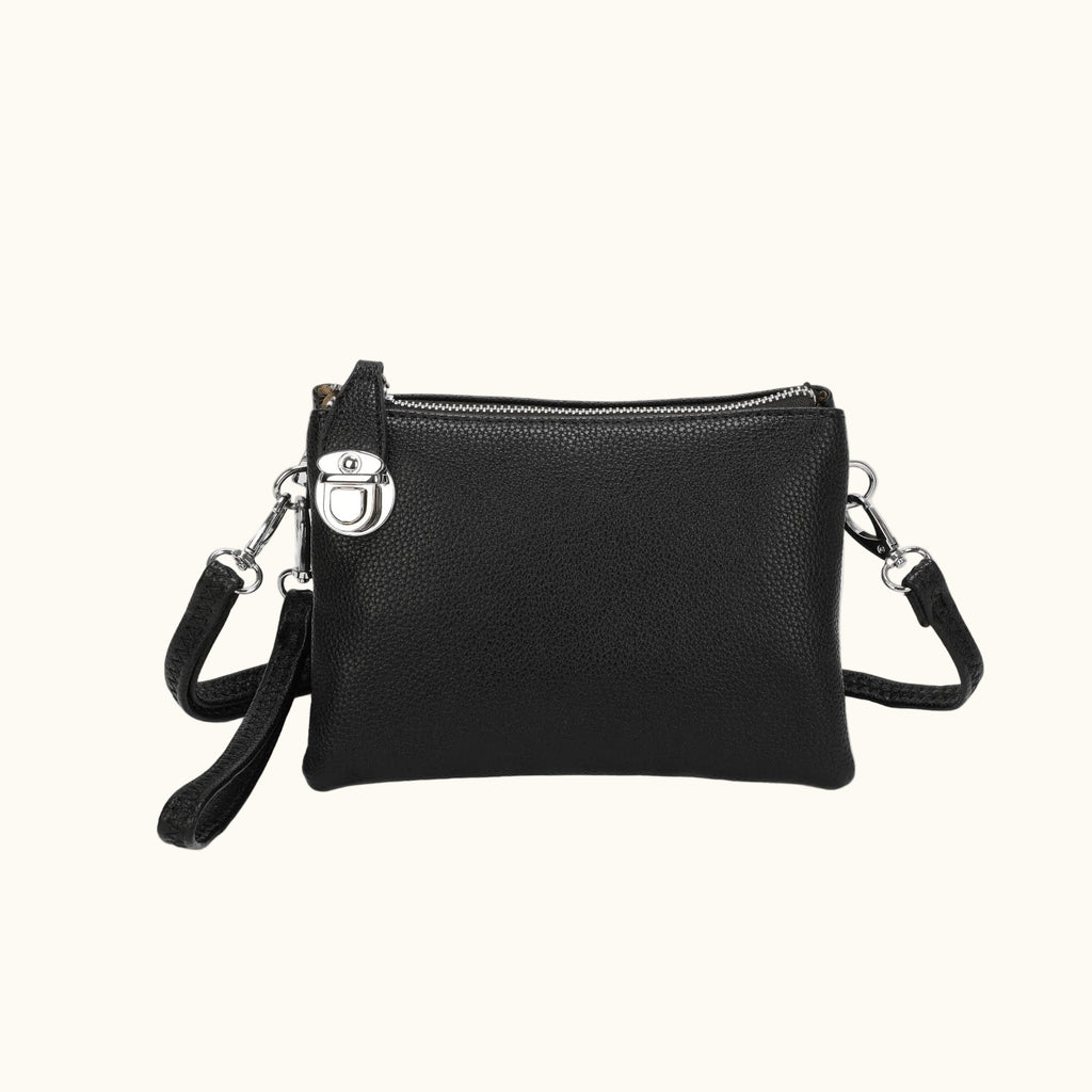 Black leather crossbody bag with a strap on a white background