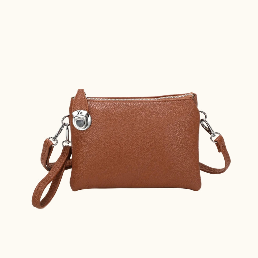 Brown leather crossbody bag with silver clasp on a white background