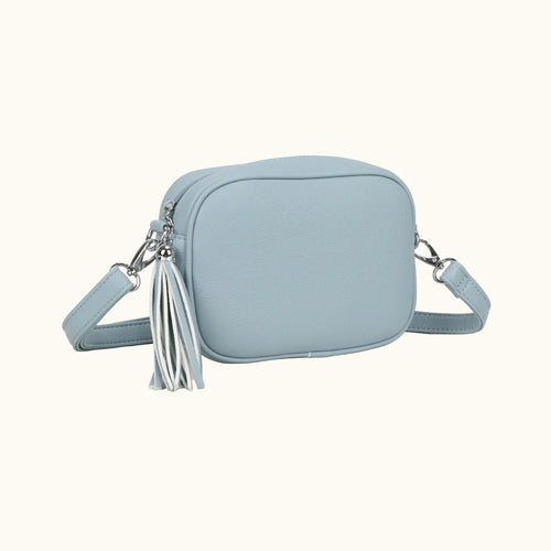 Light blue crossbody bag with a tassel on a white background