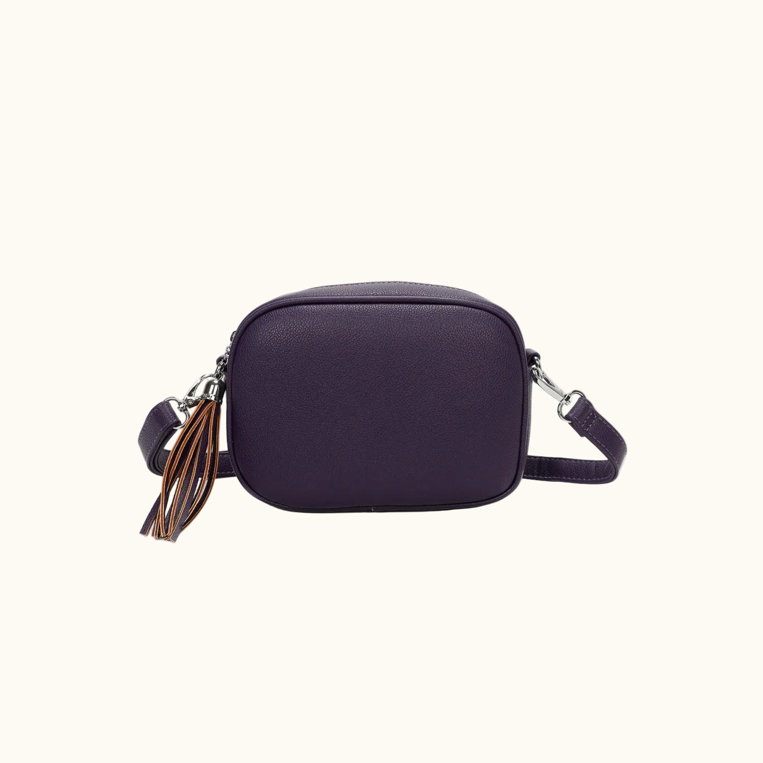 Purple crossbody bag with a tassel on a white background