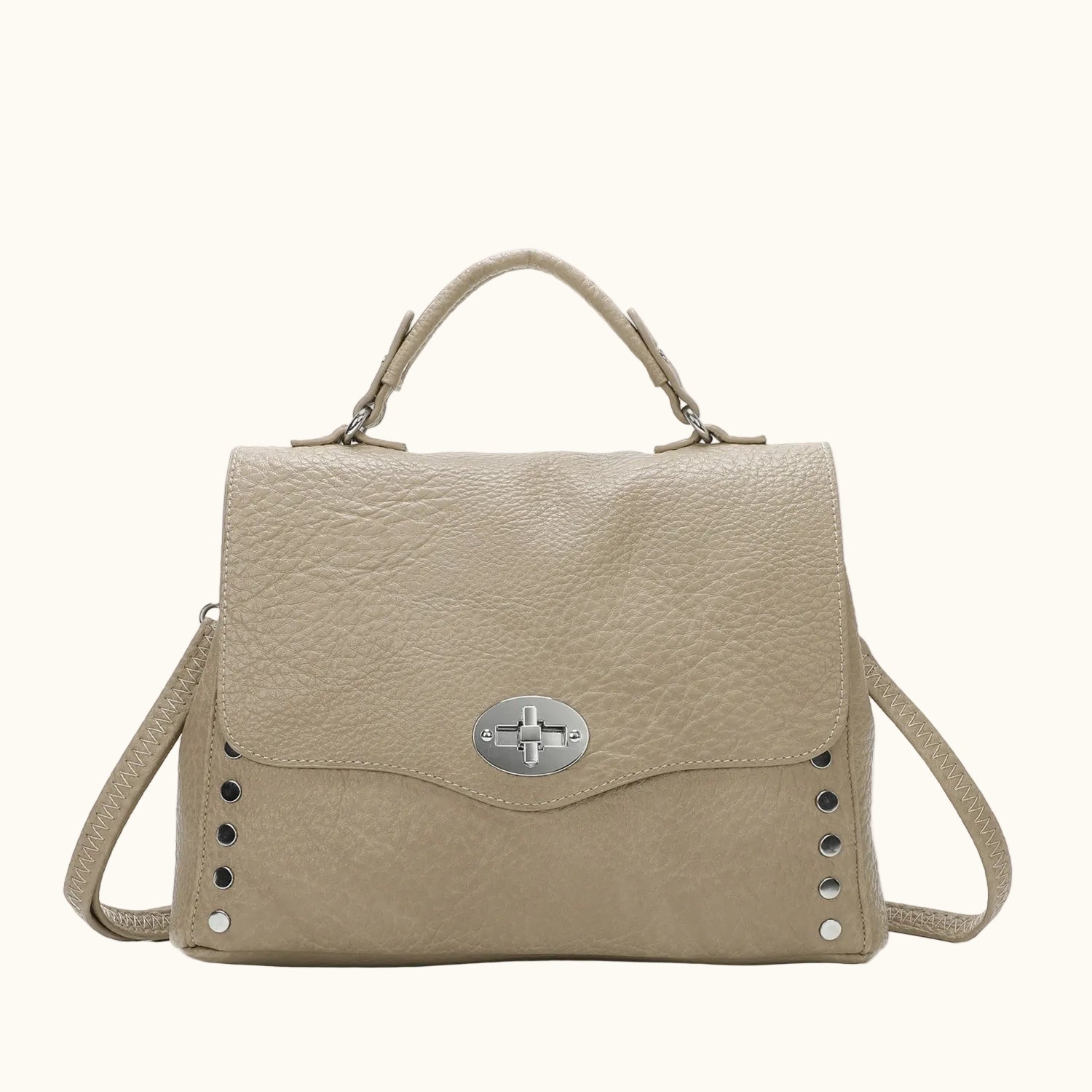 Beige handbag with a silver clasp on a white background