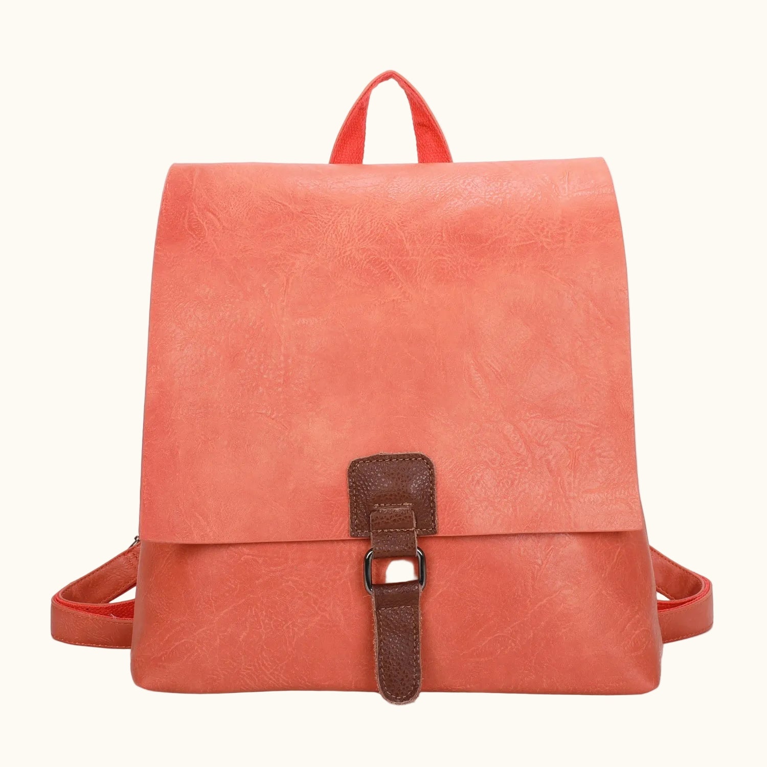 Coral backpack with a brown strap on a white background