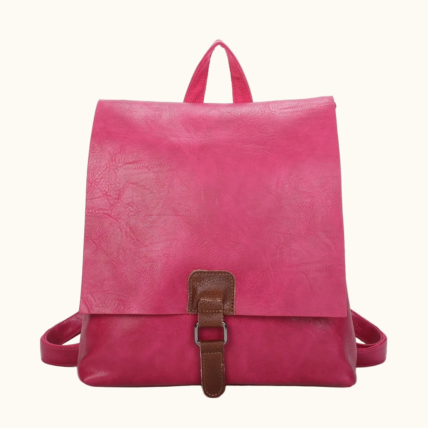 Pink backpack with a brown buckle on a white background
