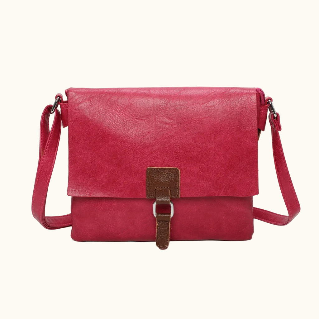 Red leather handbag with a brown strap on a white background