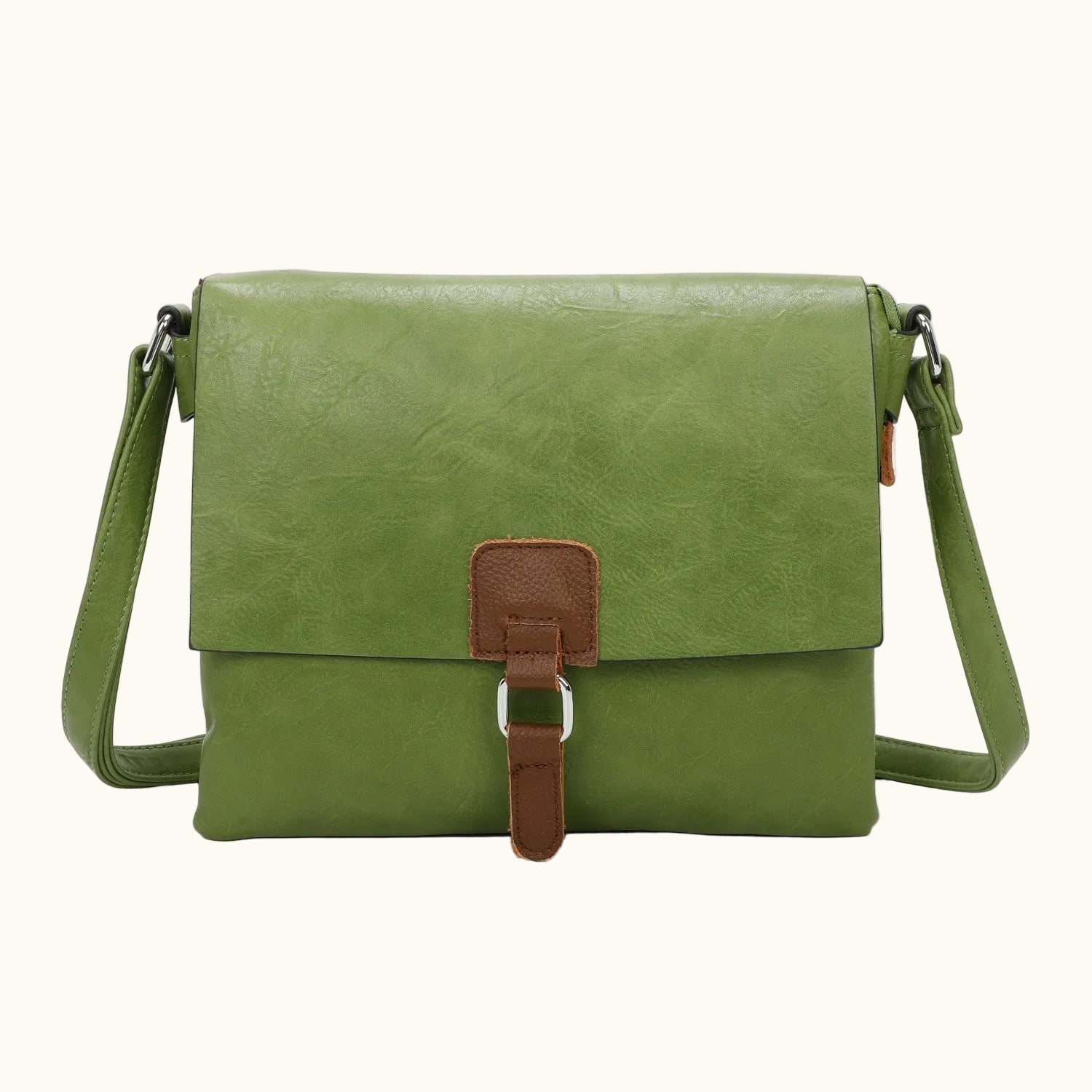 Green leather crossbody bag with brown strap on a white background