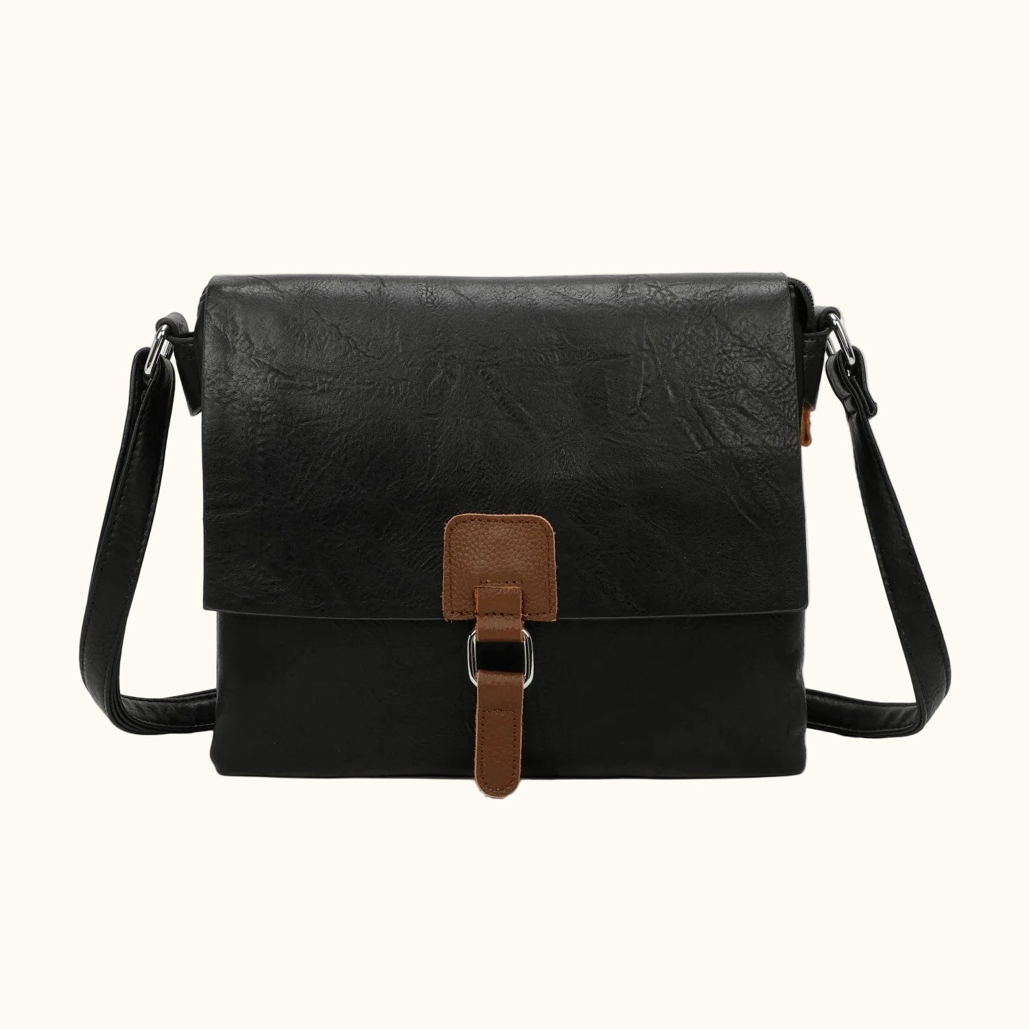 Black leather crossbody bag with brown accents on a white background