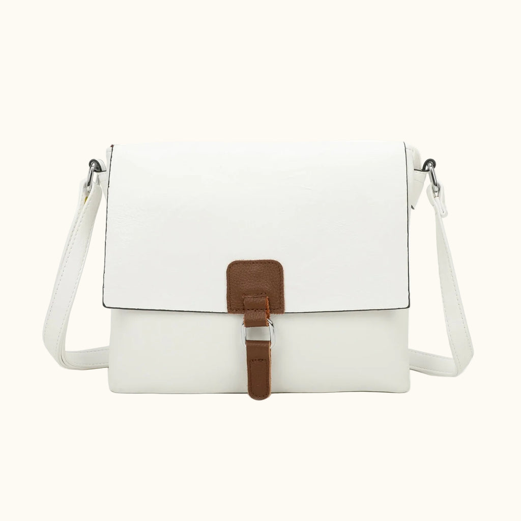 White crossbody bag with a brown strap on a white background