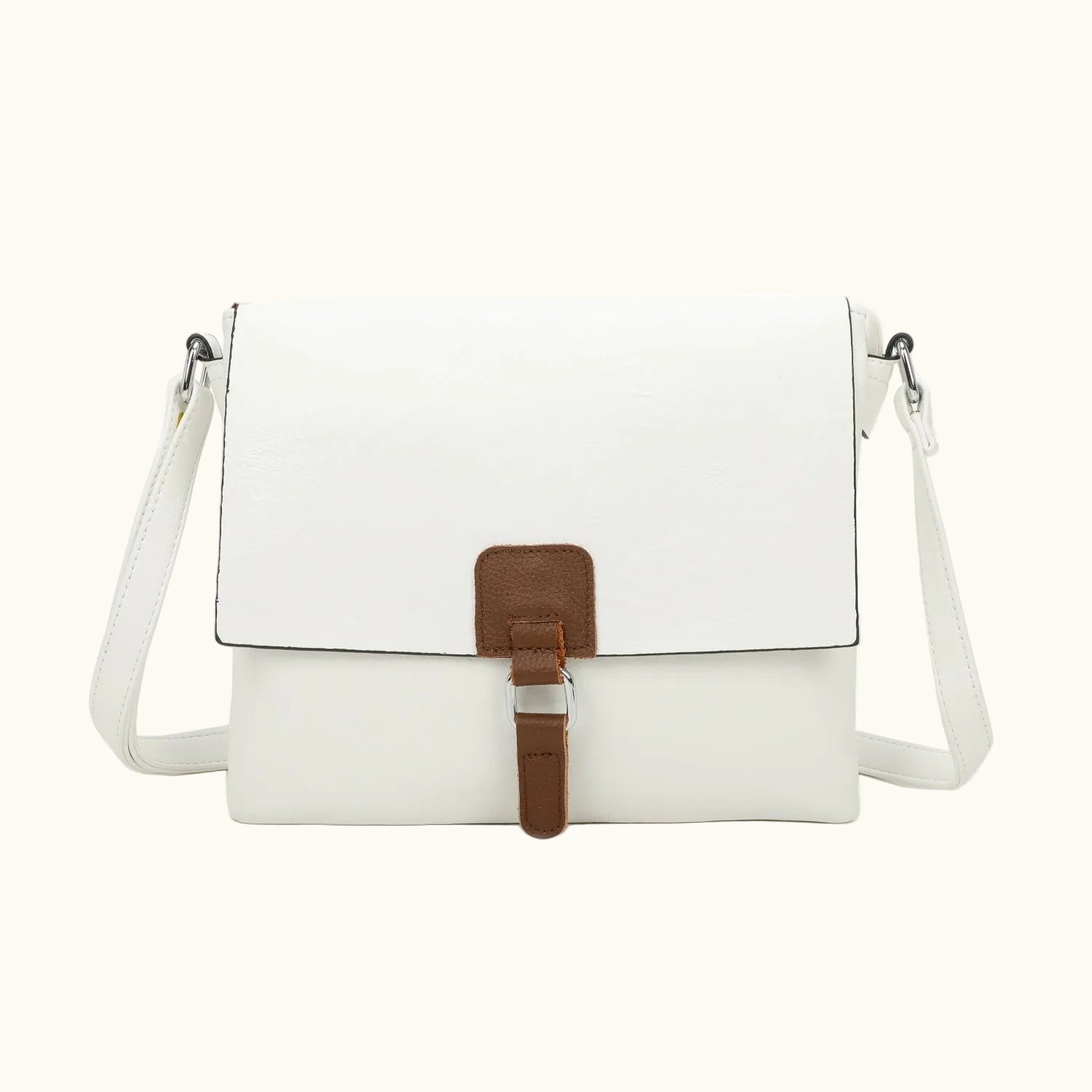 White crossbody bag with a brown strap on a white background