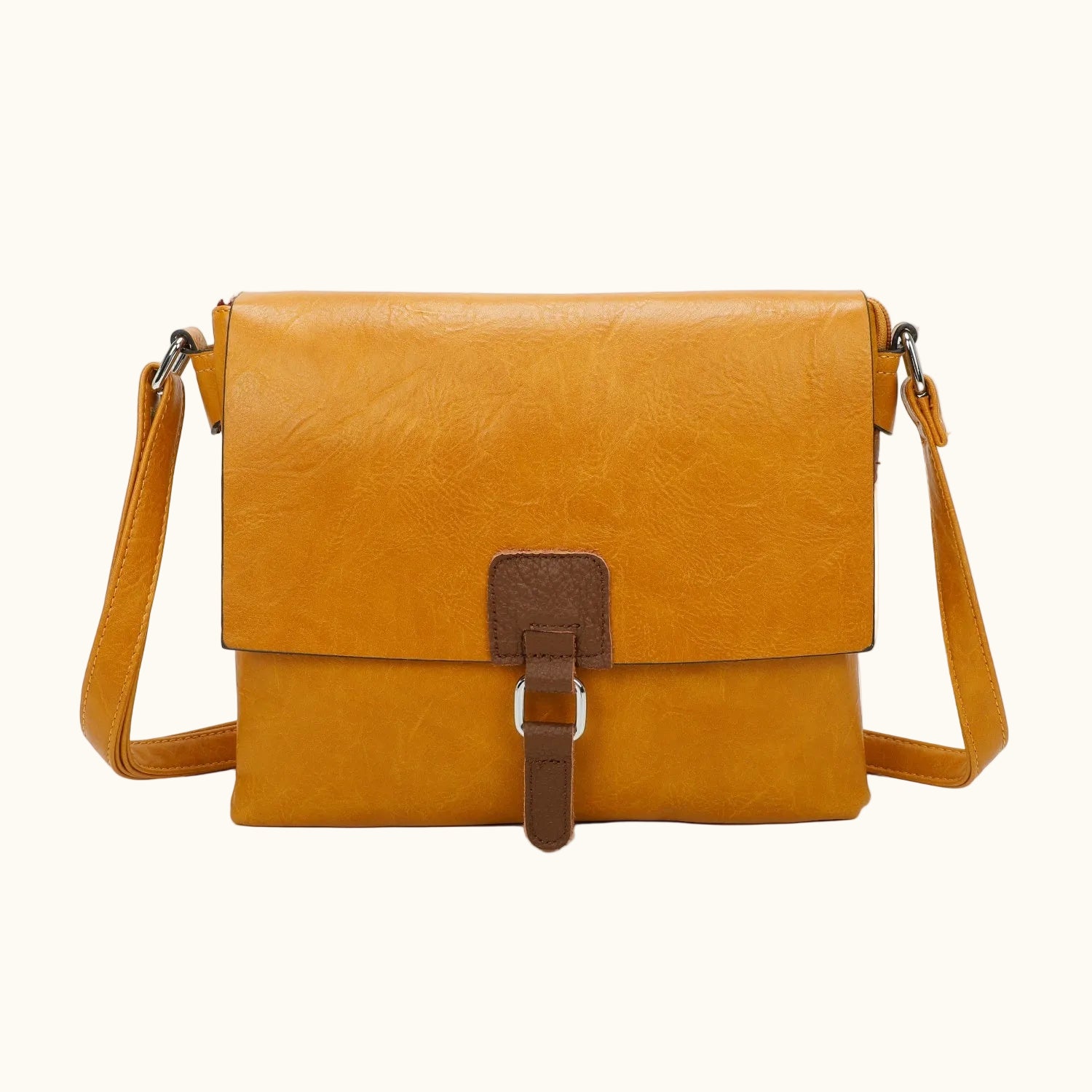 Orange leather crossbody bag with a brown buckle on a white background