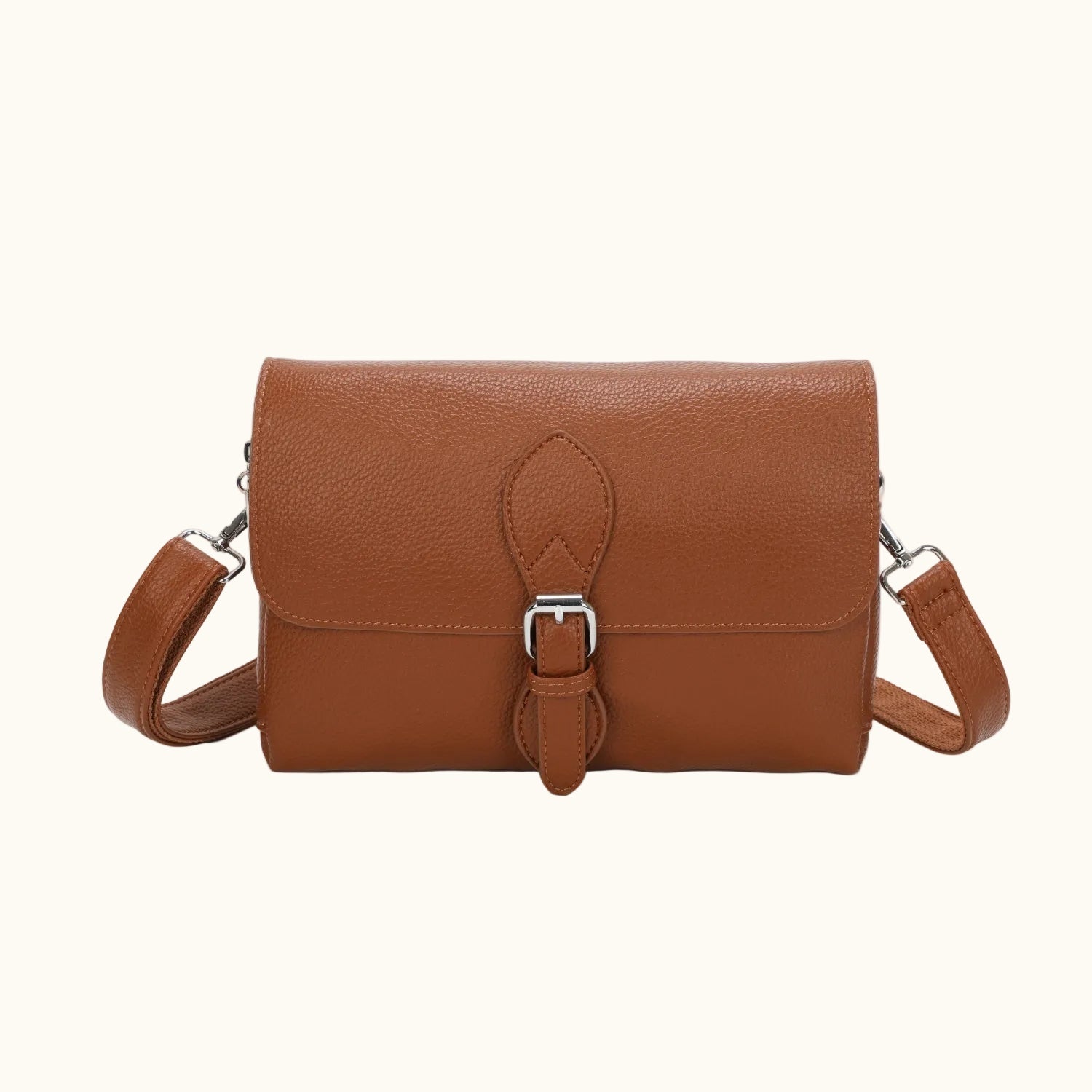 Brown leather handbag with a buckle on a white background