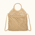 Beige woven handbag with a strap on a white background