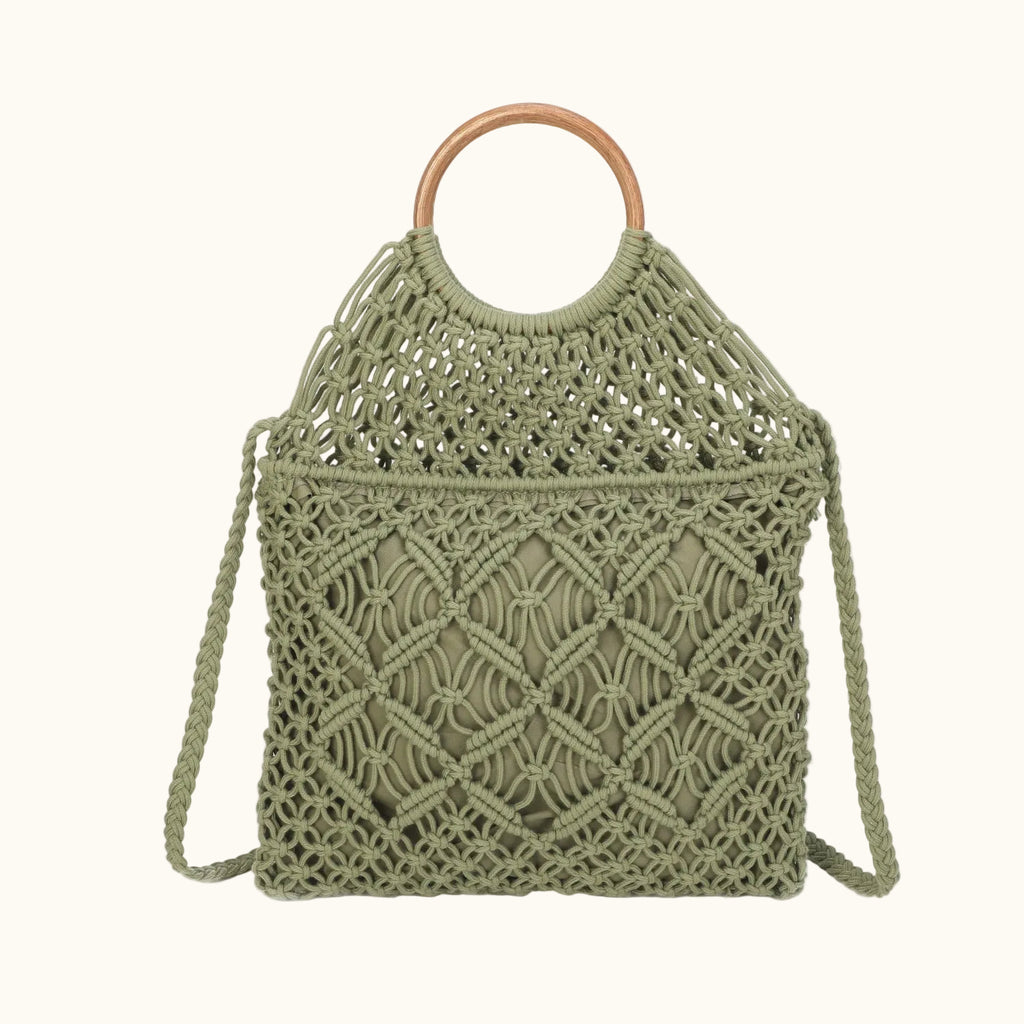 Green woven handbag with wooden handle on a white background