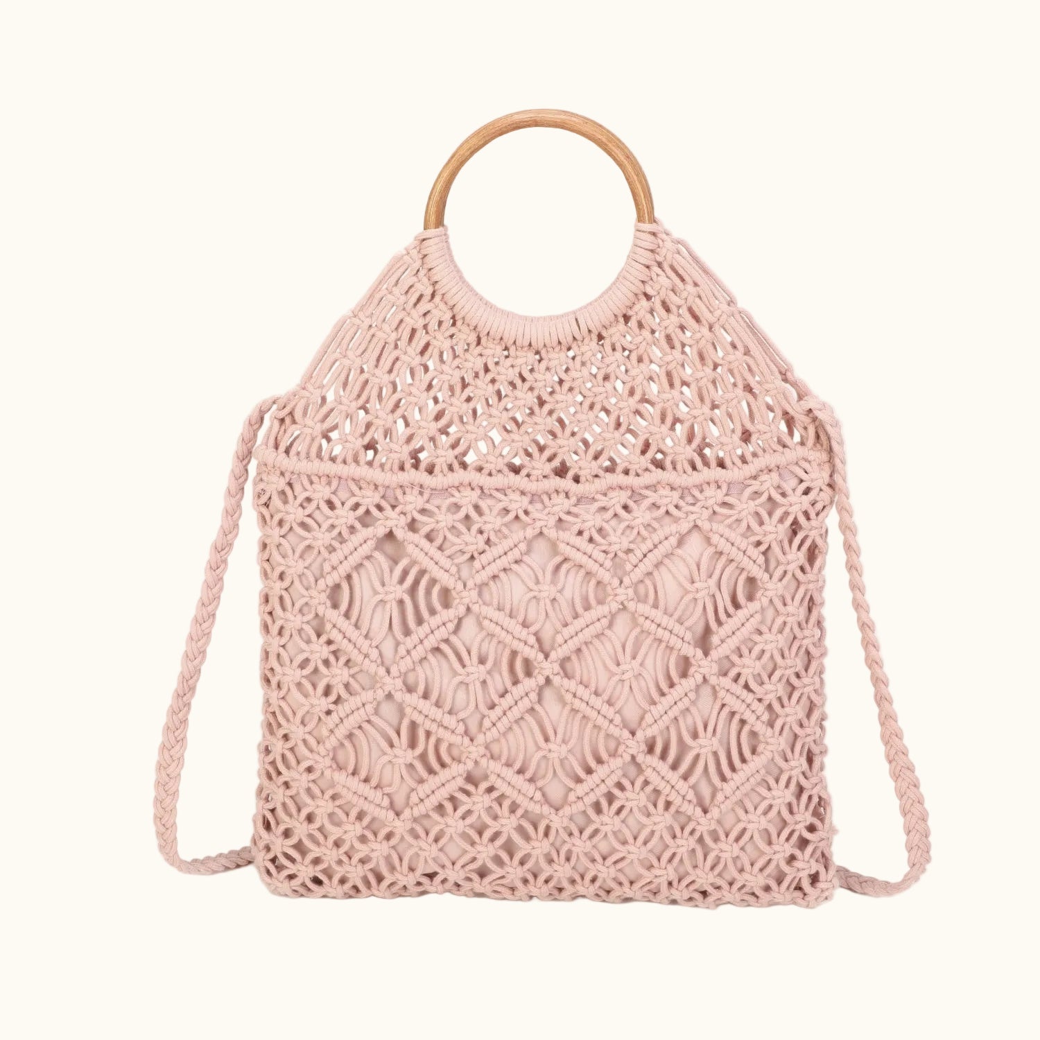 Pink woven handbag with wooden handle on a white background