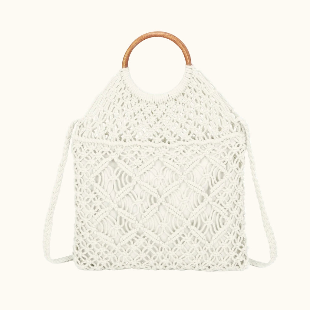 White woven bag with a wooden handle on a white background