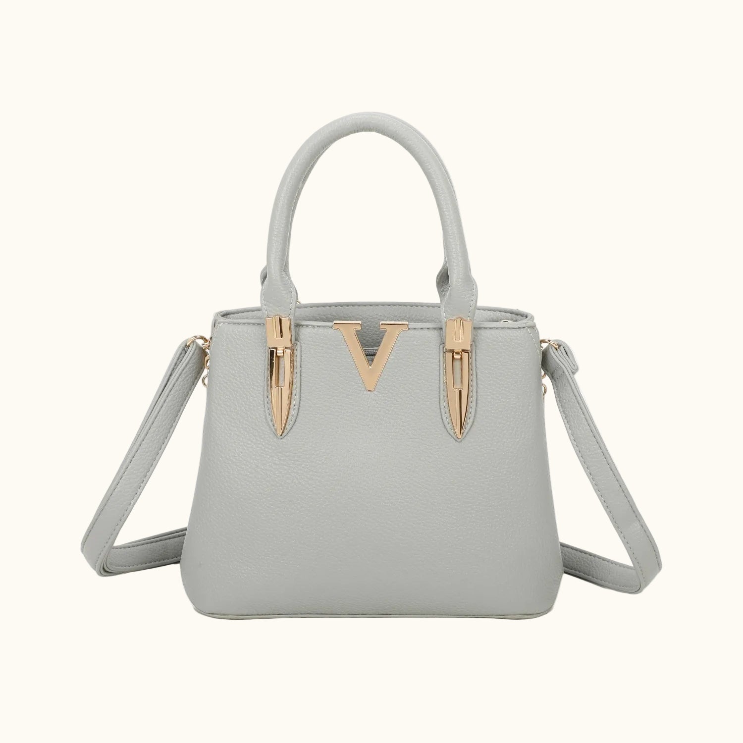 Gray handbag with a decorative strap on a white background