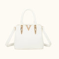 White handbag with gold accents on a white background