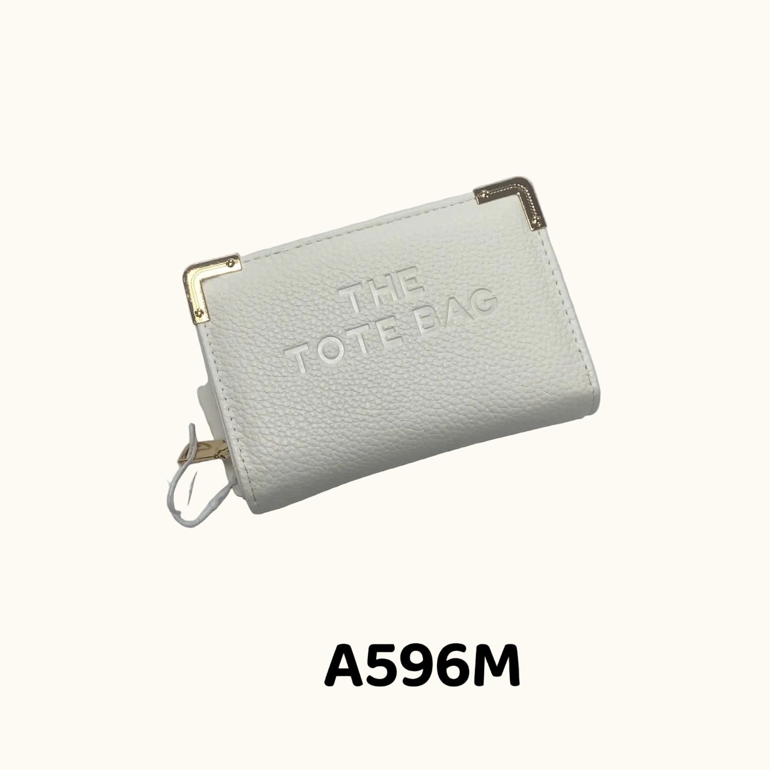 White pouch with 'THE TOTTE BAG' text on a gray background