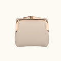 Beige clutch bag with rose gold frame on a white background