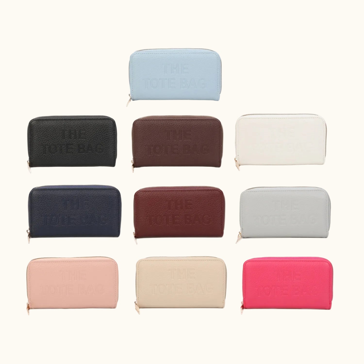 Collection of various colored 'THE TOTE BAG' pouches on a white background