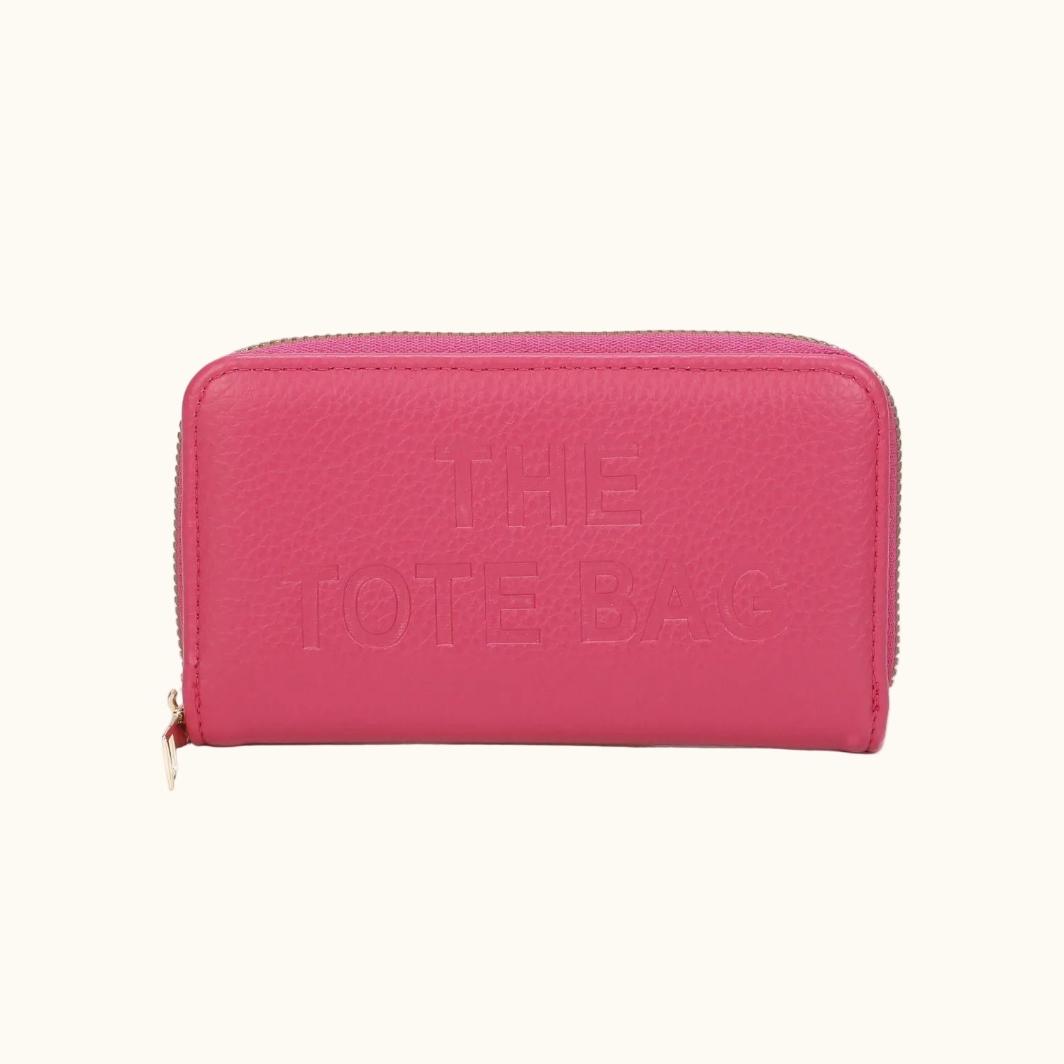 Pink wallet with 'THE TOTE BAG' text on a white background