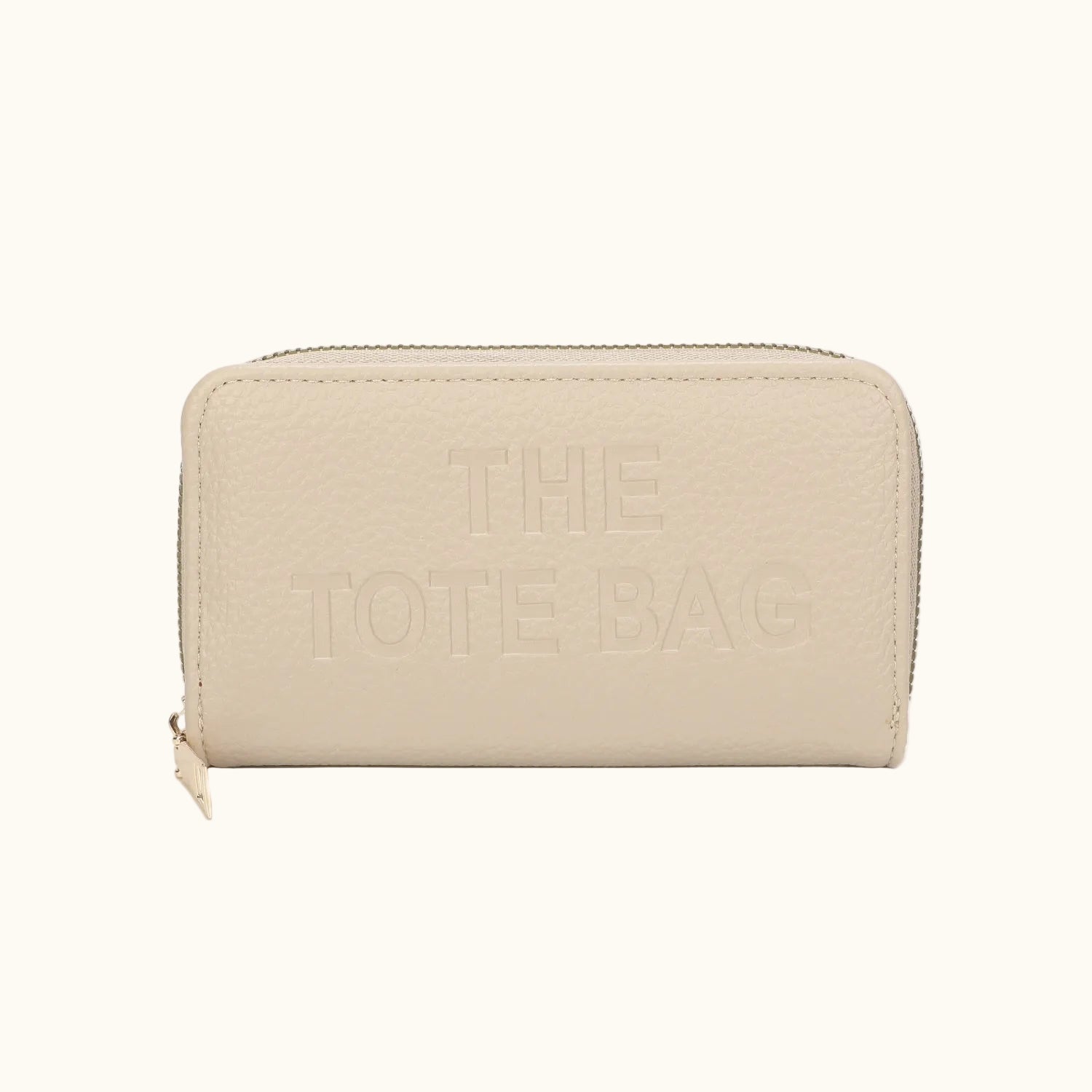 Beige wallet with 'THE TOTE BAG' embossed on a white background