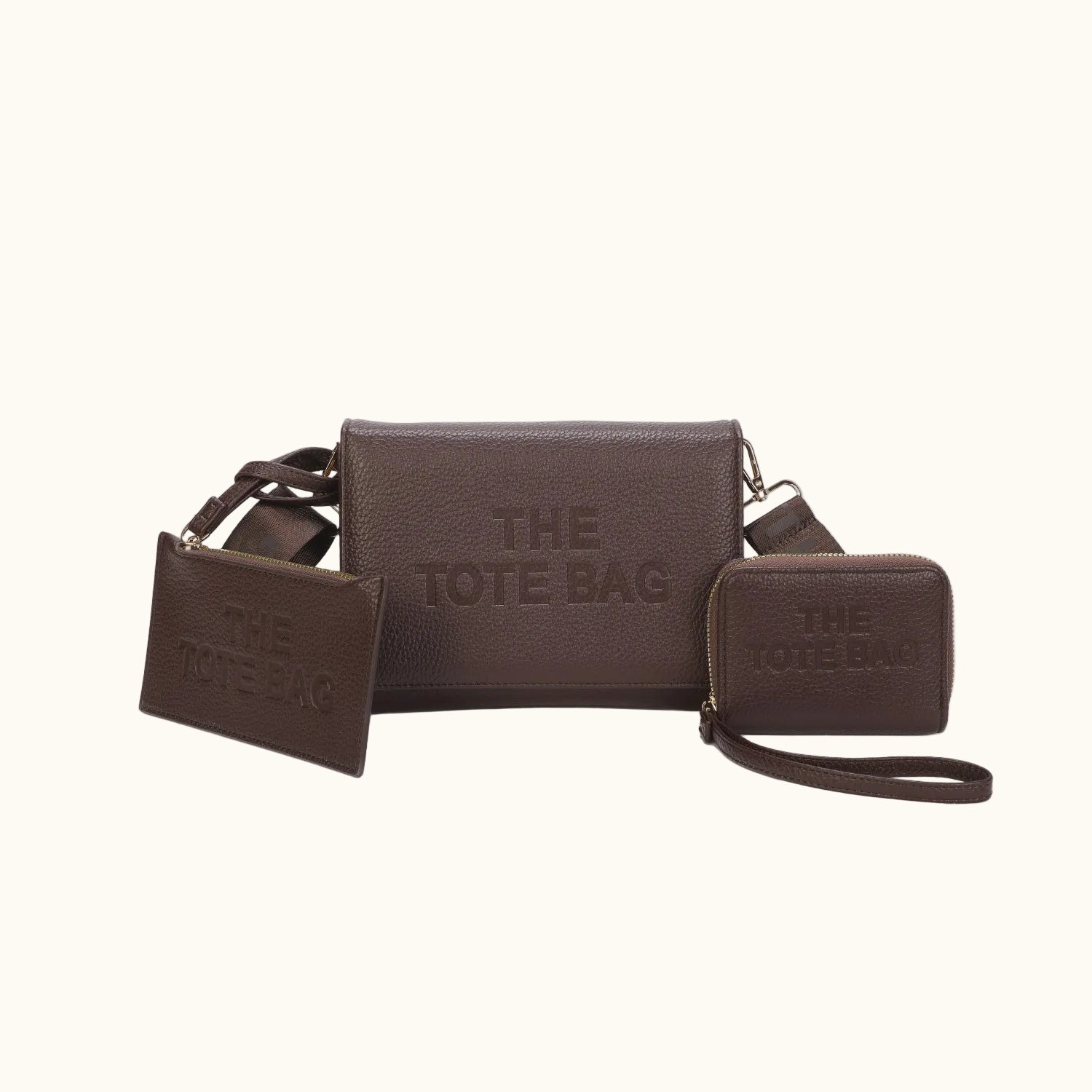 Brown leather tote bag with matching wallet and pouch on a white background