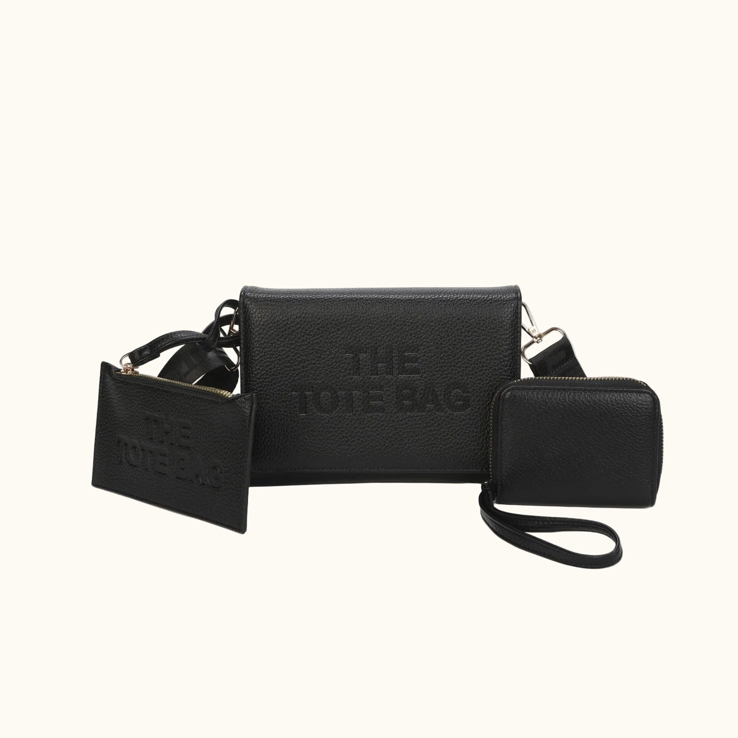 Black leather tote bag with matching wallet and pouch on a white background