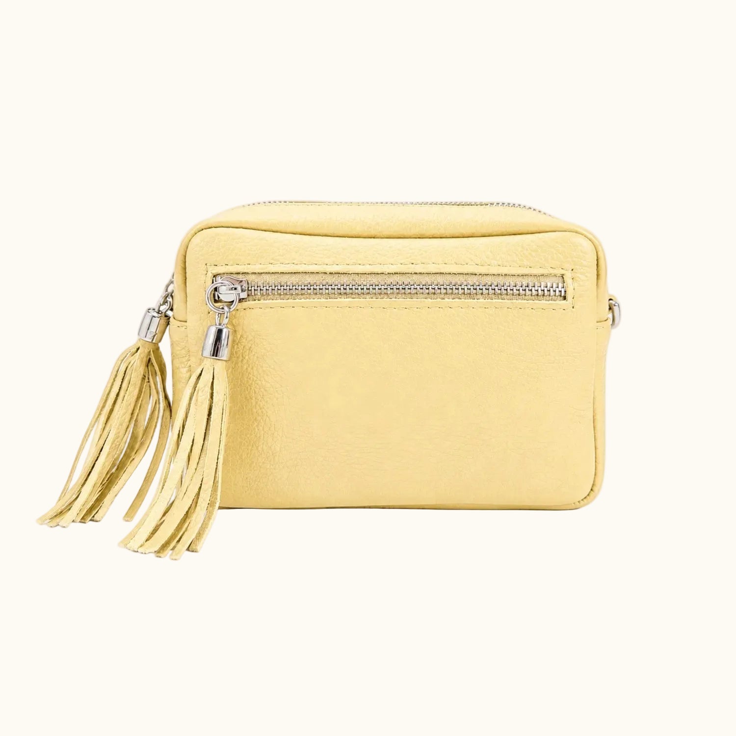 Yellow crossbody bag with a tassel on a white background