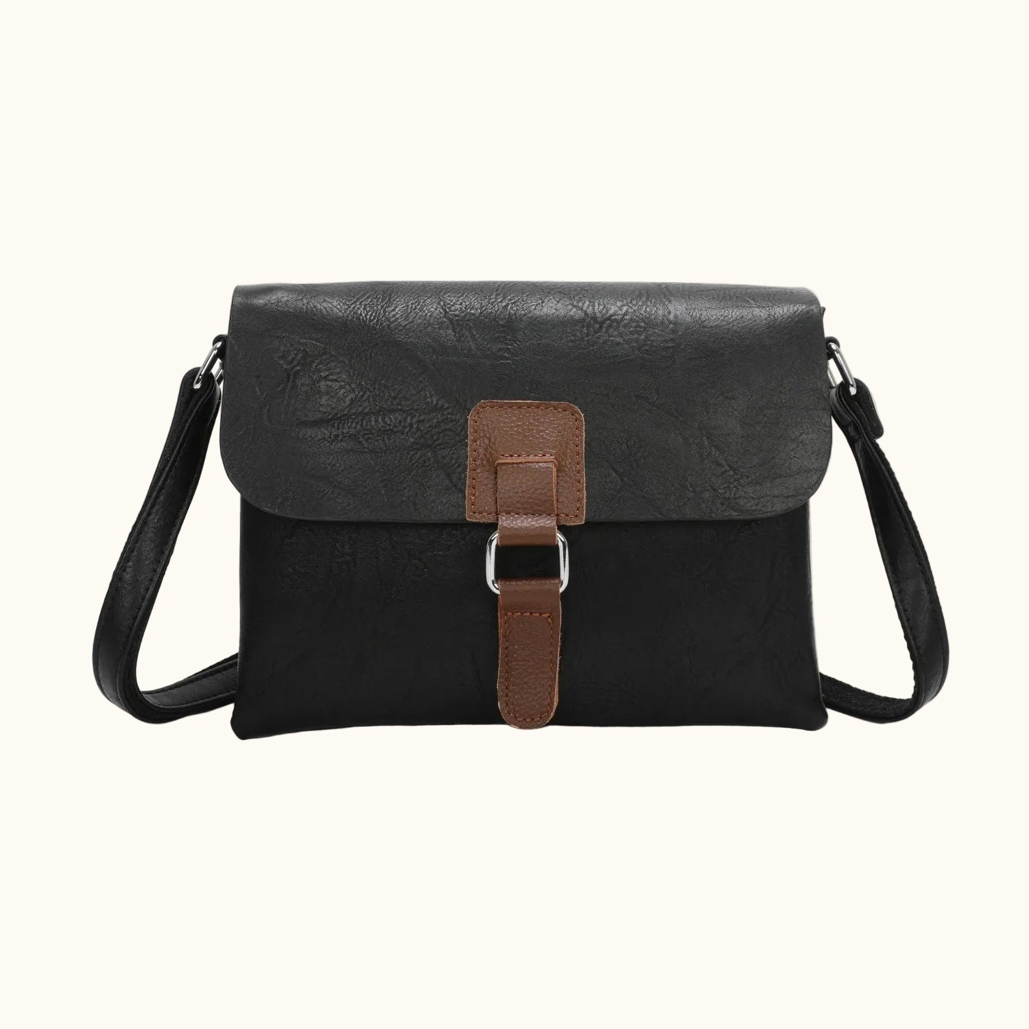 Black leather crossbody bag with a brown strap on a white background