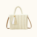 Straw handbag with tassel on a white background