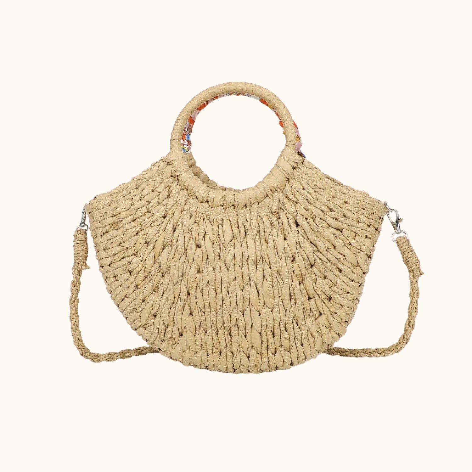 Beige woven handbag with a handle and crossbody strap on a white background