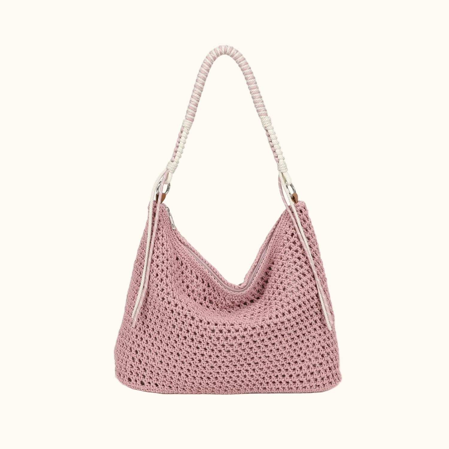 Pink crochet handbag with a white handle on a white background