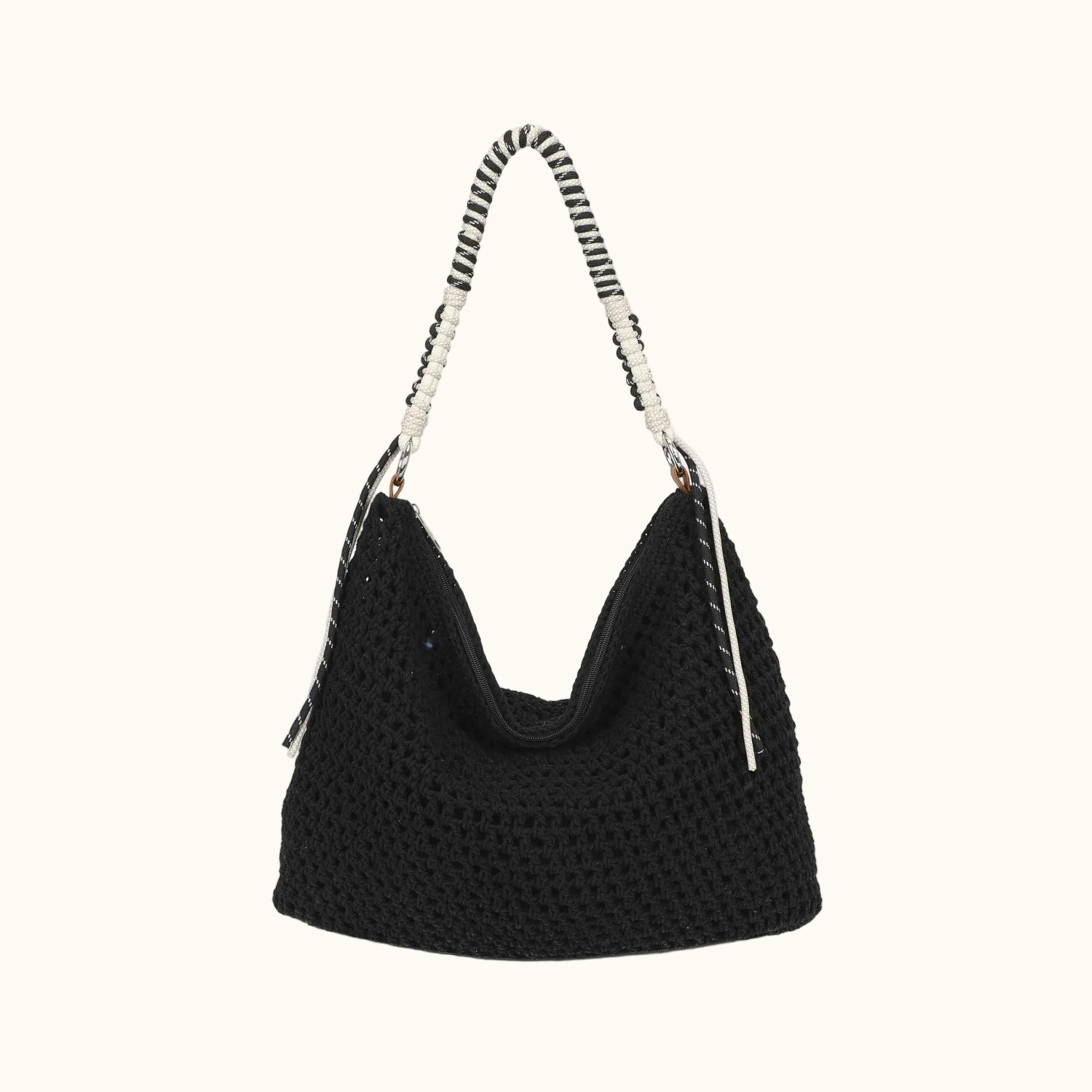 Black textured handbag with a patterned handle on a white background