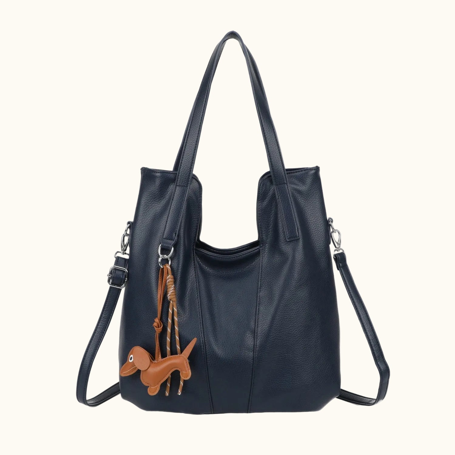Black leather handbag with a brown dog charm on a white background