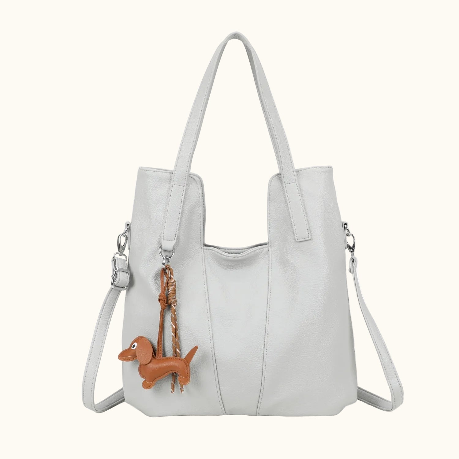 White handbag with a dachshund charm on a white background