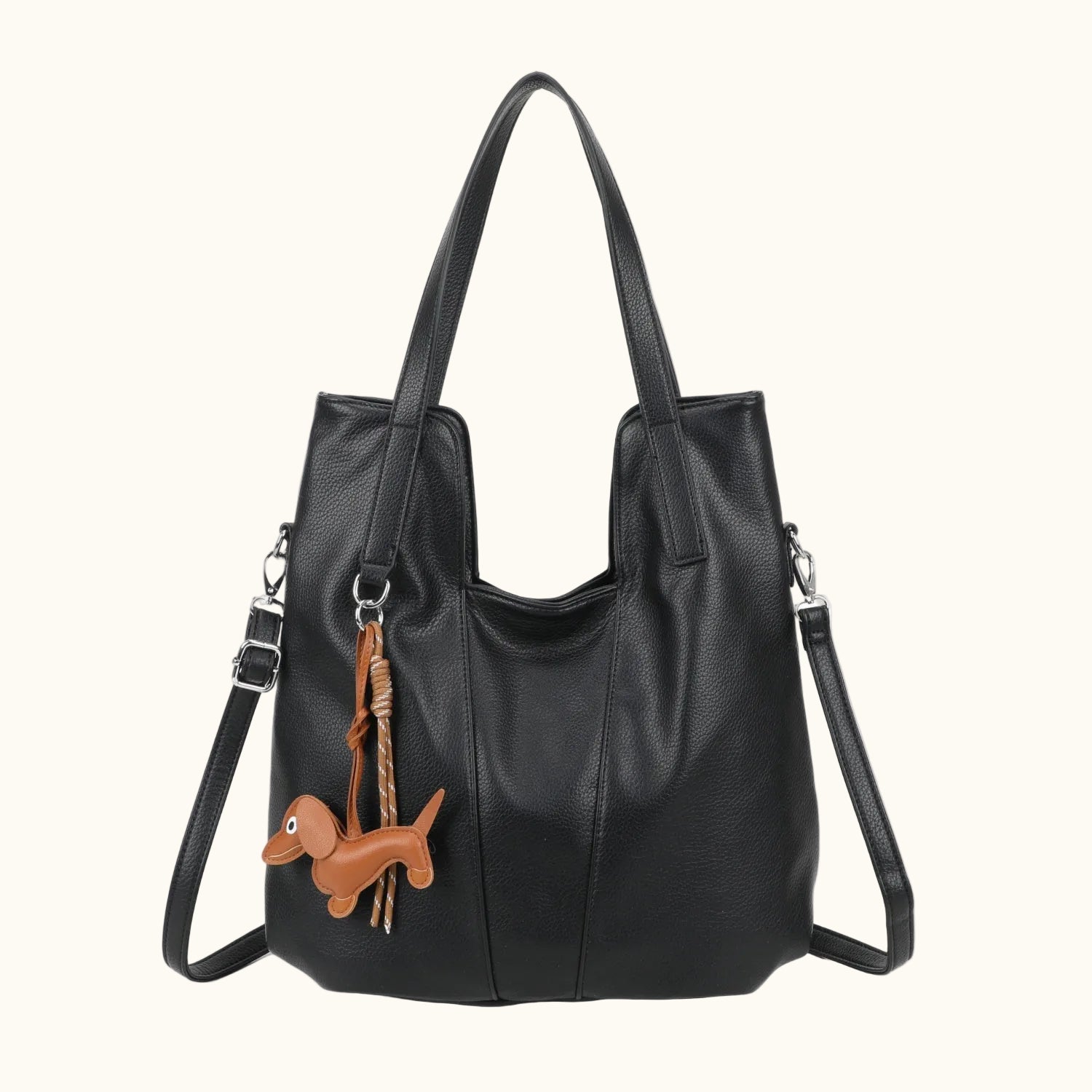 Black handbag with a dachshund charm on a white background