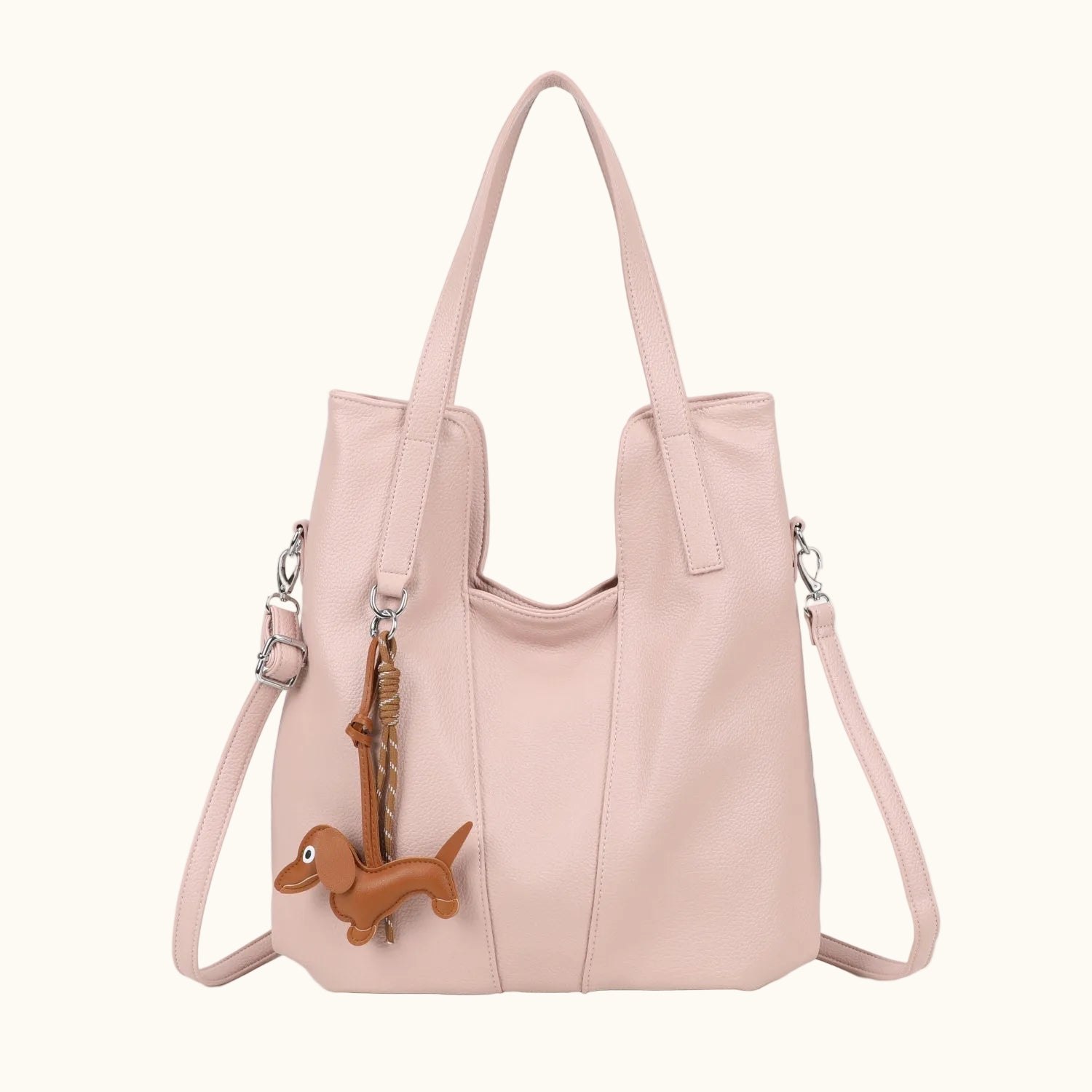 Pink handbag with a brown dog charm on a white background