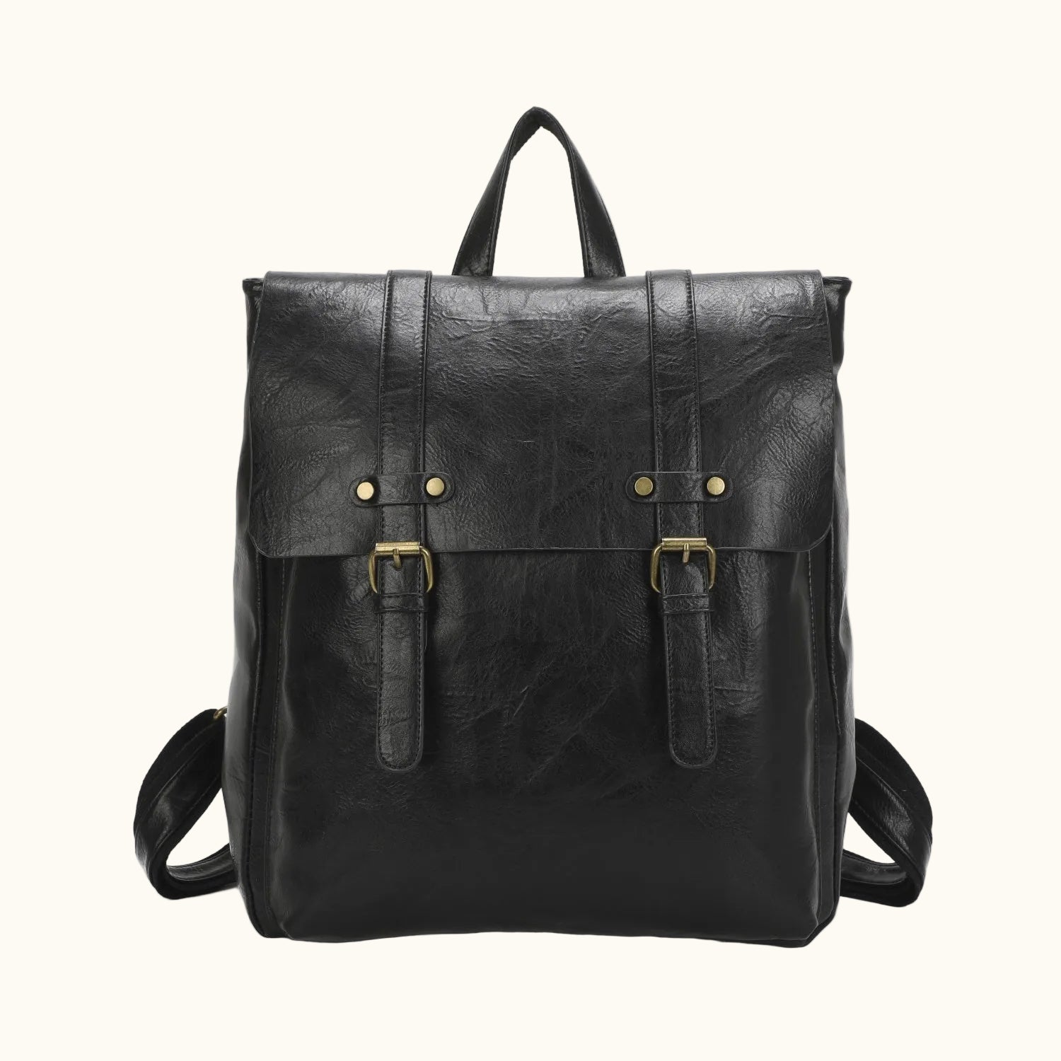 Black leather backpack with gold buckles on a white background