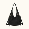 Black handbag with fringe details on a white background