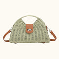 Green woven handbag with brown leather accents on a white background