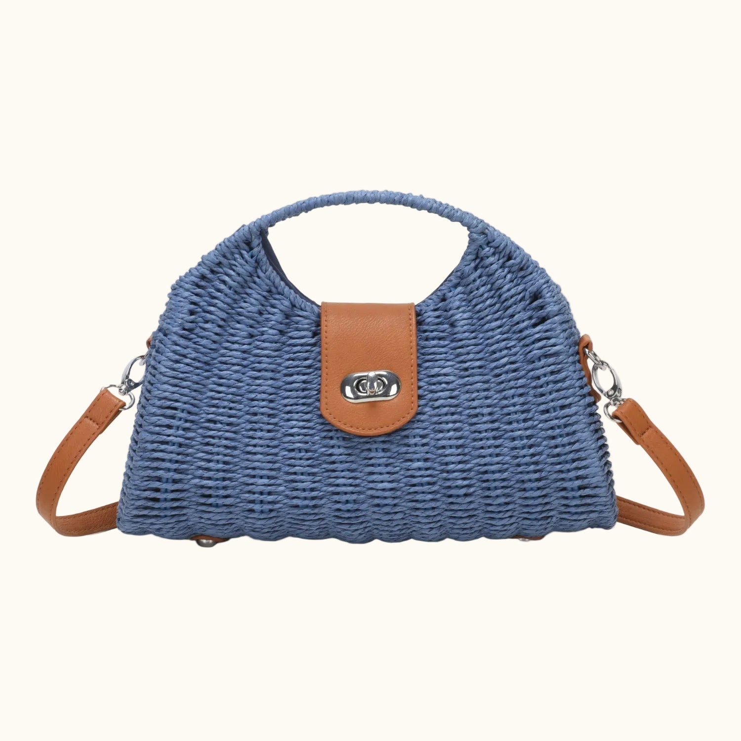 Blue woven handbag with brown leather accents on a white background