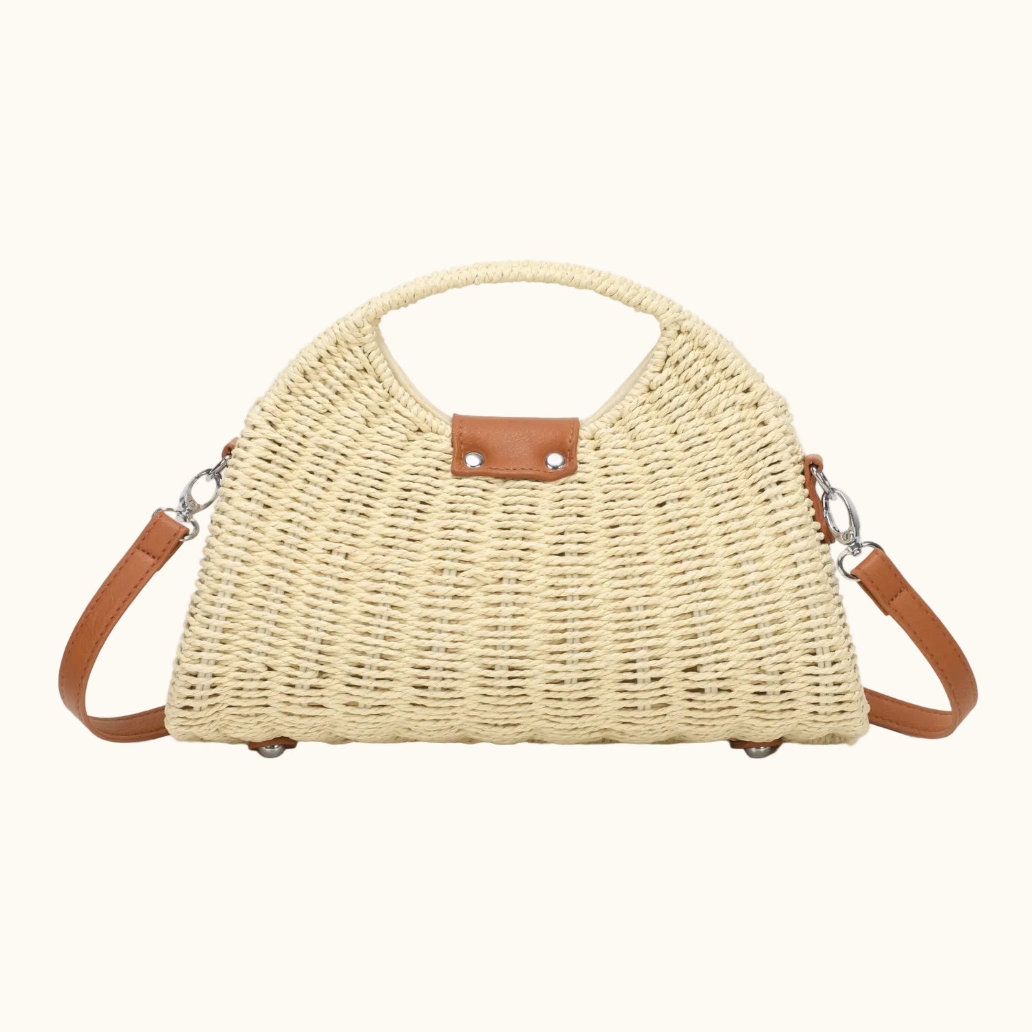 Woven handbag with leather straps on a white background